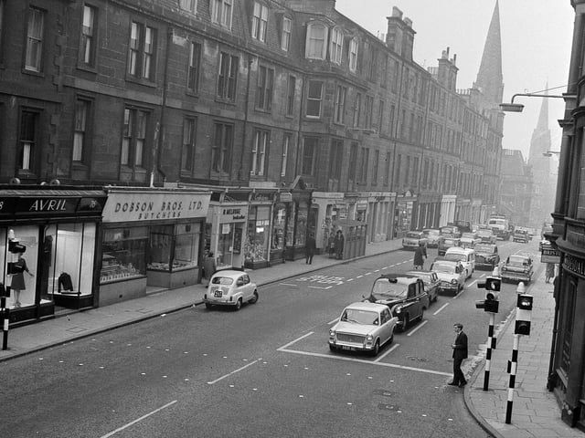 Looking north to Holy Corner from the junction of Church Hill and  Morningside Road in Edinburgh in 1964 - including Dobson Bros the butchers , Avril dress shop, and Melrose the bookseller.
