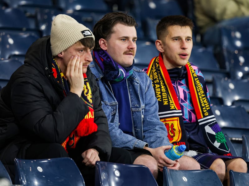 A trio of Scotland fans await the introduction of the players to the pitch.