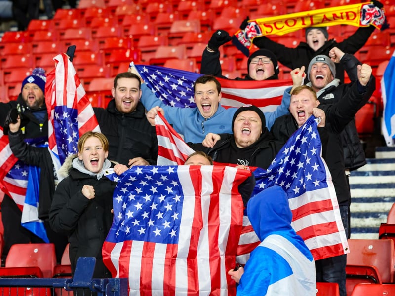 Scotland fans celebrate with USA flags at full time.