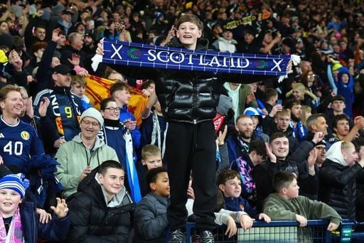 A Scotland fans beams with delight at the full time whistle.