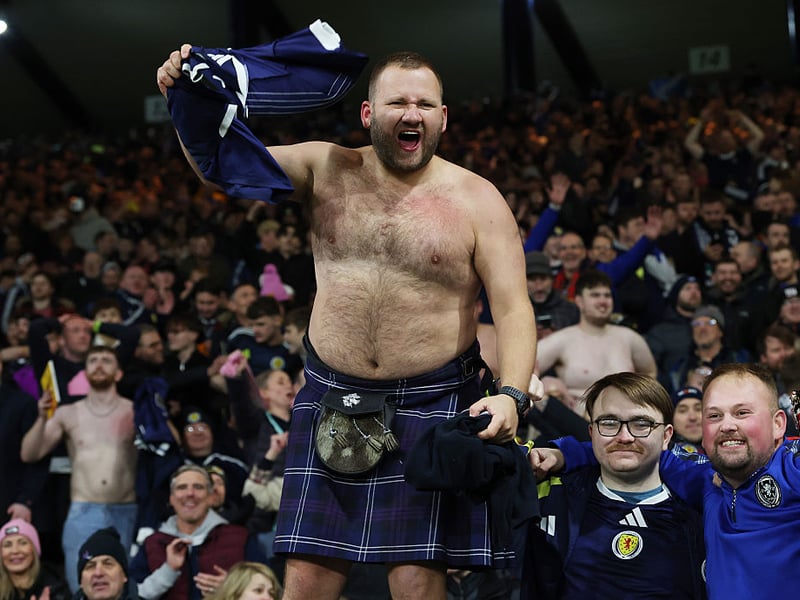 A Scotland Fan celebrates after the team's victory at Hampden Park.