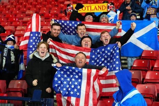 Scotland fans with flags of the United States of America celebrate after they qualified for the 2026 World Cup after beating Denmark 4-2.