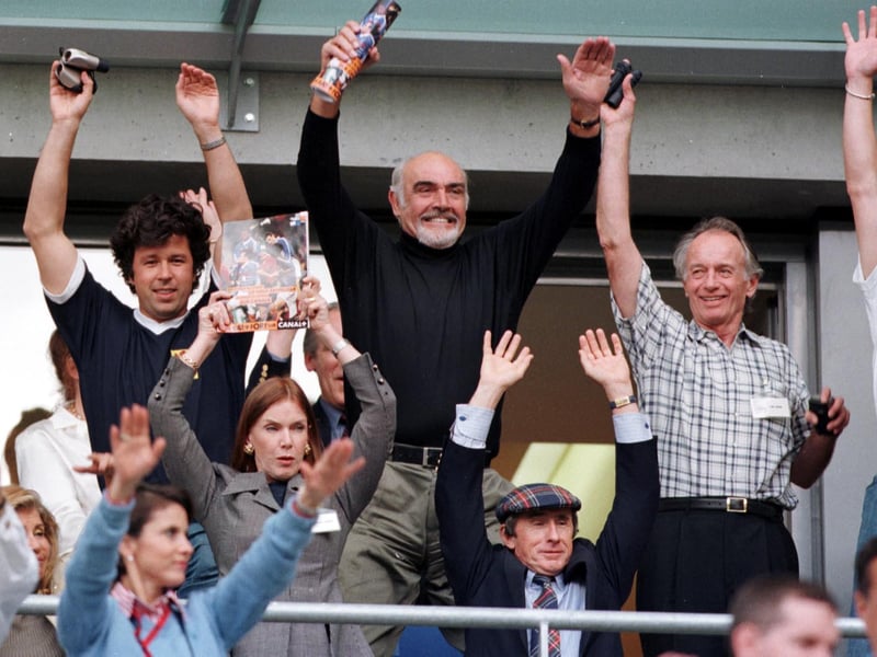 Sir Sean Connery joins in the Mexican wave during the Scots game against Brazil.