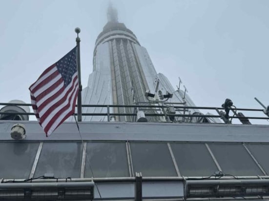 Looking up to the top of the Empire State building.