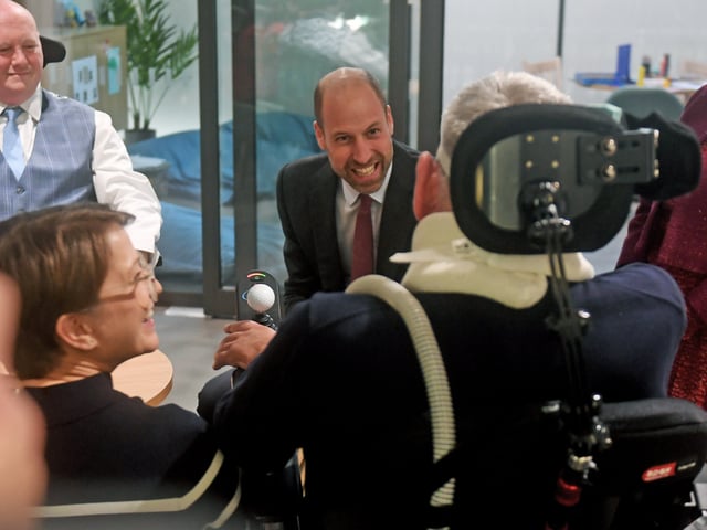 The Prince of Wales is pictured chatting to patient Ian Flatt with his wife Rachel at the opening. 

