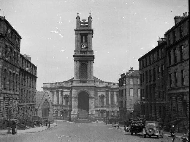 The exterior of St Stephens Church with cars and other vehicles in 1956.