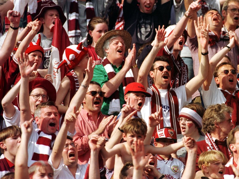 Hearts fans salute their team who have just beaten Rangers 2-1 to lift the Scottish Tennents Cup in May 1998