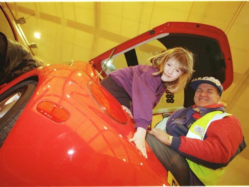Kathryn Grubb, aged six, tries the boot of the new VW for size with George Grant at the Bathgate Volkswagen Show in 1998