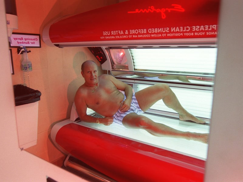 Kai Johansen, of Consol Suncenter, on his slot machine sun bed in Maryhill, Glasgow, in 1998