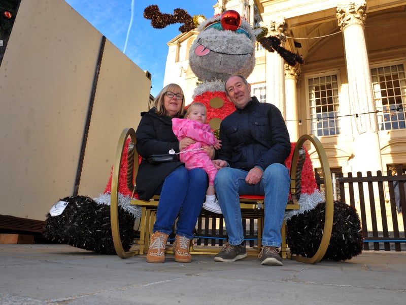 Karen Godfey and granddaughter Sofia Grace, and Gary Butterfield relax in Millennium Square.
