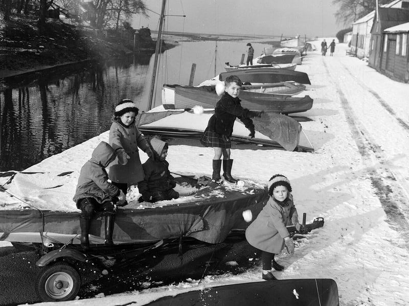 Children playing on the snow-covered boats at Cramond near Edinburgh in February 1963