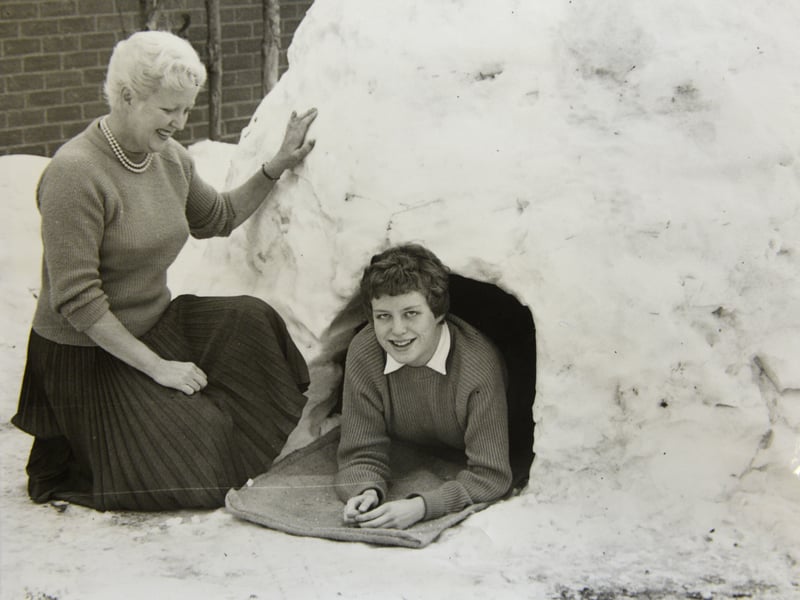 An igloo and its proud owner during heavy snow in Bedfordshire in 1962