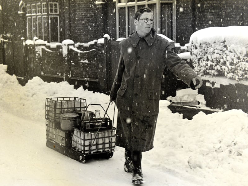 A milkman makes his way through the snow in Bedfordshire with a toboggan in 1947