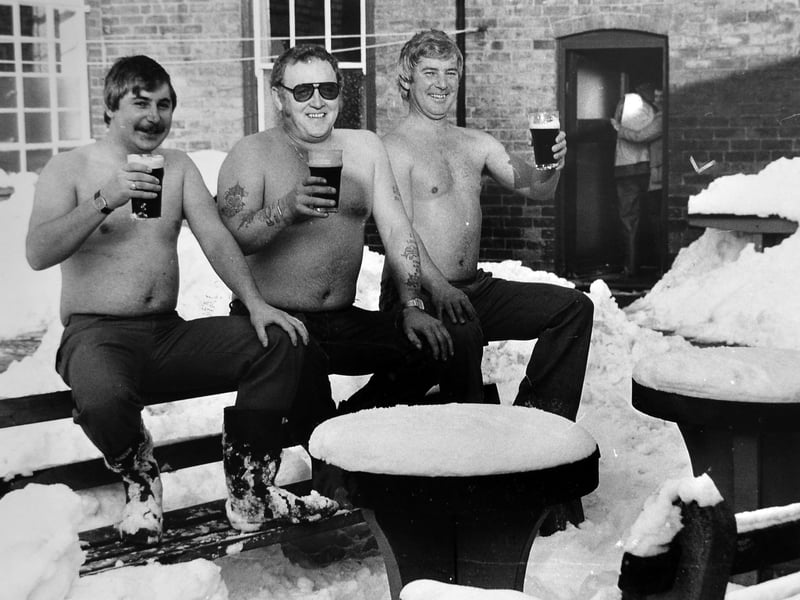 Three regulars at the White Horse pub in Sedgley enjoying the winter sunshine as well as a pint of good ale in January 1982