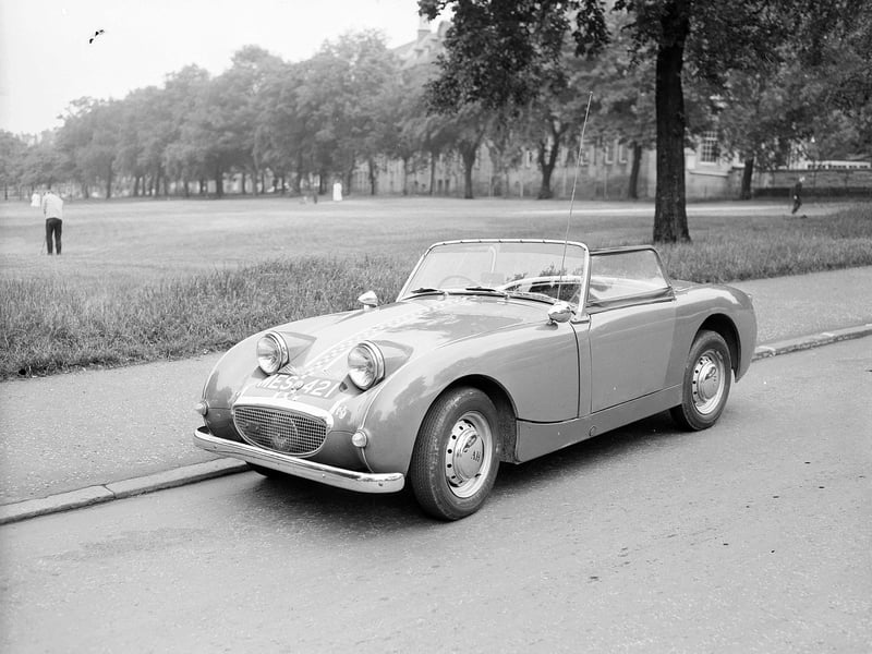 An Austin Healy Sprite on Whitehouse Loan beside  Bruntsfield Links with James Gillespie's High School in the background in July 1962.
