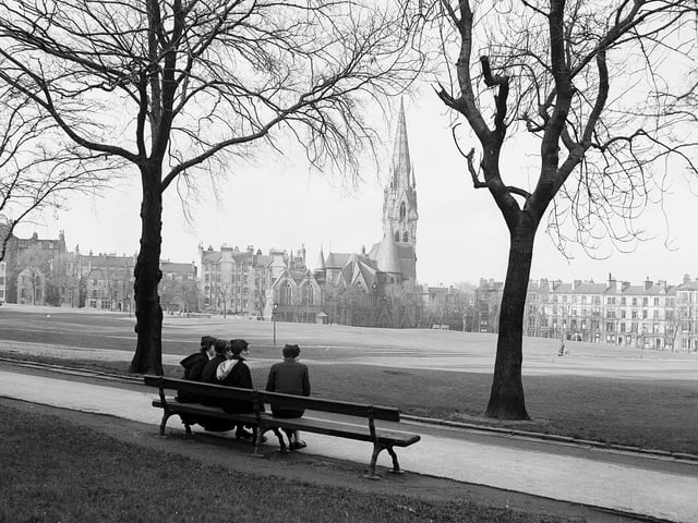Girls from James Gillespie's High School sitting on bench looking over to Barclay Church at Bruntsfield Links in January 1957.