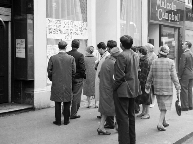 Crowds gather round a shop window in Sauchiehall Street to look at information about the Nucleur Defence Plan in April 1963.
