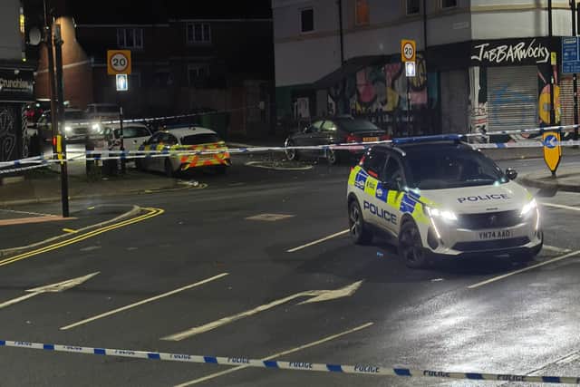 Police at the scene on London Road following the shooting
