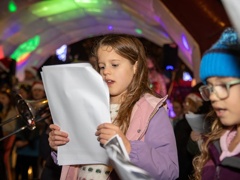 Local school children helped get everyone in the festive spirit by singing carols.