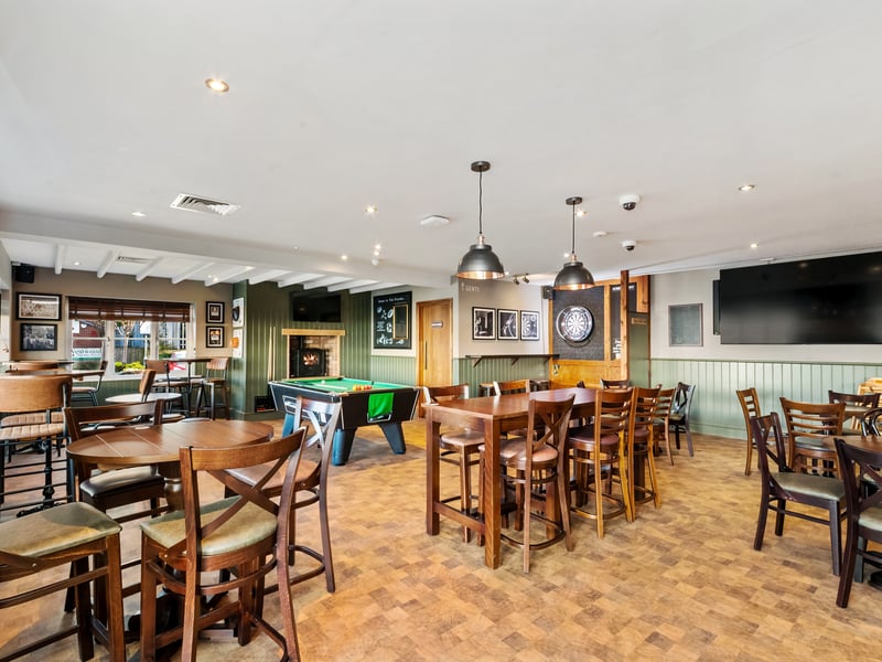 The space also includes a dedicated darts area and pool table.
