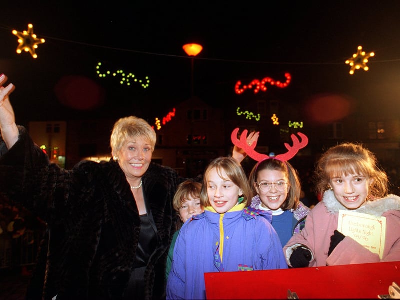 Actress Liz Dawn, better known as Coronation Street's Vera Duckworth, pictured with local school children after switching on the Christmas lights in December 1995.