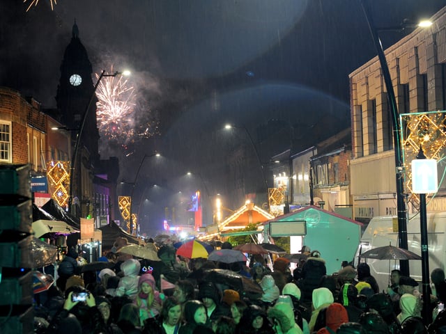 Crowds gather for the festive event, despite the rain.