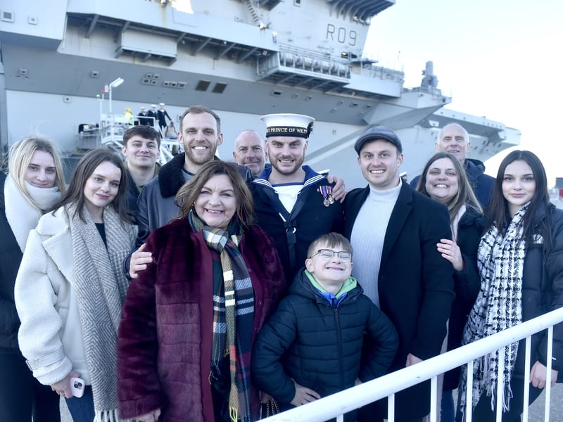 Pictured is: (middle) Leading Hand Joseph Mellor was the first sailor to step ashore from HMS Prince of Wales. He was greeted by mum Karen (fifth from left) and the rest of his family.