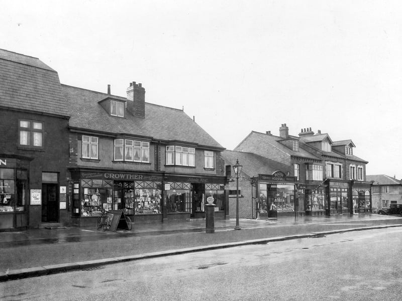 Crossgates Road in November 1933. A row of shops, from left number 90, George Green butcher, then 88 William Crowther, newsagent. Next is number 86 Sheila West, ladies wear, number 84 Booth and Horsfall dairymen. Number 82 Sidney Maughan, barber. Number 80 Eric Allen, butcher, finally number 78 Edward Mitchell chemist..