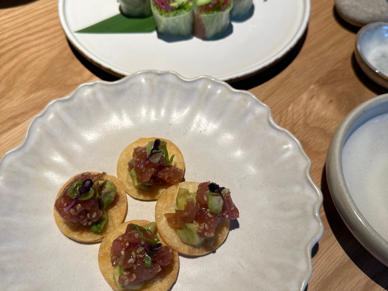 On our first visit we ordered the Perfect Day set menu. That starts with edamame - soya beans with sea salt, with
tuna tartare bites serves with avocado, sesame, miso,
yuzu and spring onion on crispy flat bread - the tuna is vibrant and fresh. Mushroom croquette with Danish Rød
Krystal cheese, miso aïoli and a dusting of truffle dust is an impressive contrast. Then rice paper wrapped soy-cured salmon served with pickled red onion, avocado, cucumber and coriander, and a sesame seed sauce for dipping.