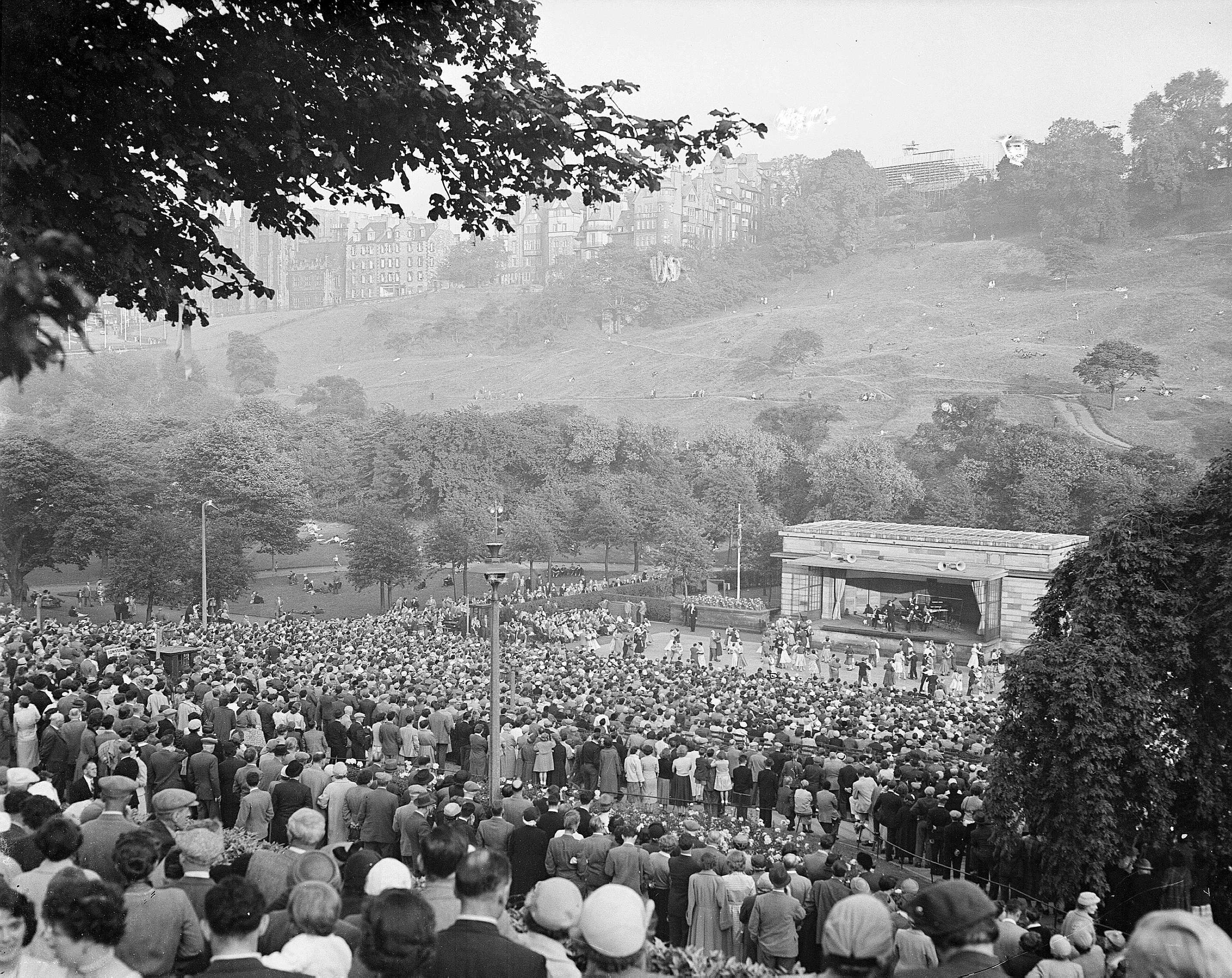 Crowds of holiday-makers watch a session of open-air dancing at the Ross Bandstand in Princes Street Gardens in July 1956.