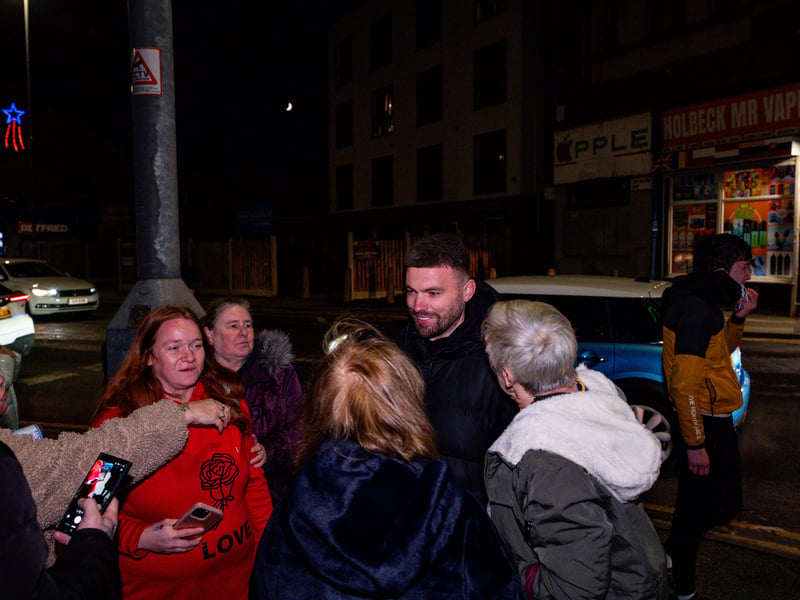 Stuart Dallas talks with fans and locals.
