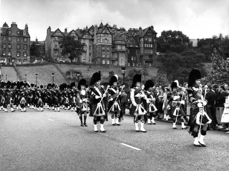 Drum Major Cockburn leads bands down the Mound to a Pipe Band Contest in Princes Street Gardens in August 1960.