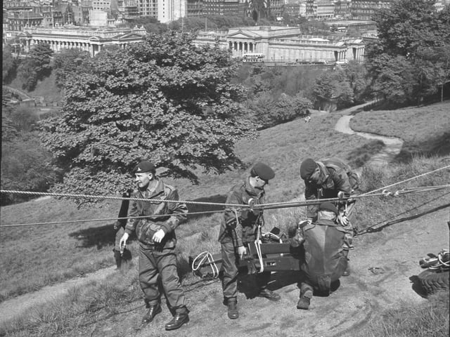 The Commando regiment of the Royal Artillery attempt an assault on Edinburgh Castle from Princes Street Gardens in May 1966 - the Howitzer has to be hauled up manually.
