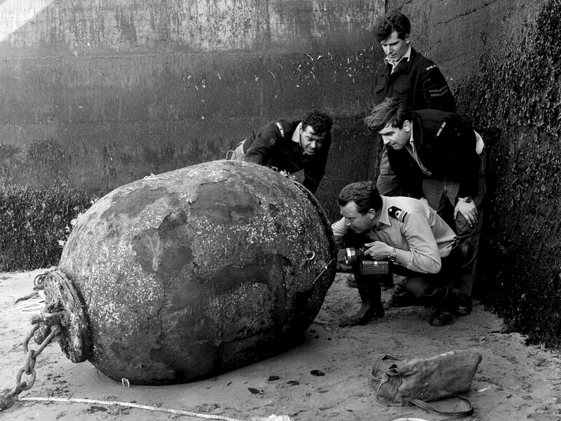 A Royal Navy bomb and mine disposal unit in South Queensferry looking at a mine from World War II in June 1965.