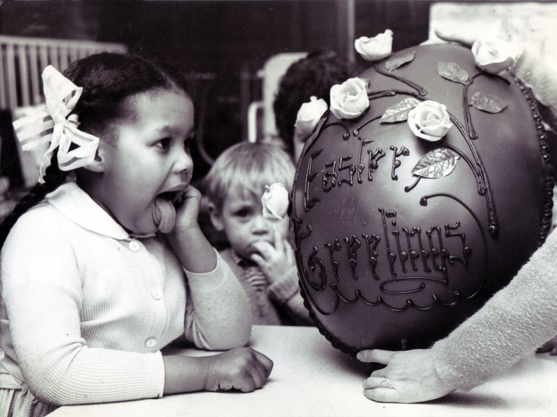 Licking her lips in anticipation of the forthcoming feast is Four-year-old Patricia Wells, one of the patients at Sheffield Children's Hospital, who helped to dispose of this giant Easter egg presented to the hospital by Walsh's department store in March 1967