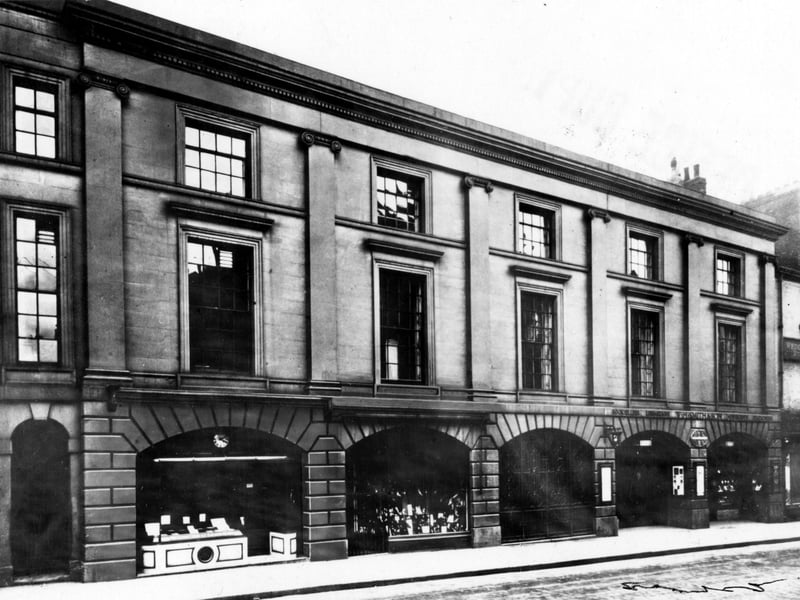 This view shows W.H. Smith booksellers and stationers shop with E. Burrows & Son bootmakers next door. The Leeds Library is on the first floor. Pictured in October 1948.
