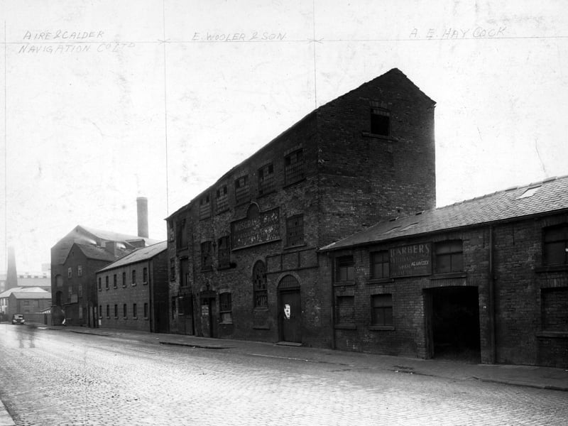 This photo from November 1948  shows mills and factories on East Street, some of which are disused. The ones that aren't are the premises of 'Aire and Calder Navigation Co. Ltd.', 'E.Wooler and Son', 'A.E. Haycock'.