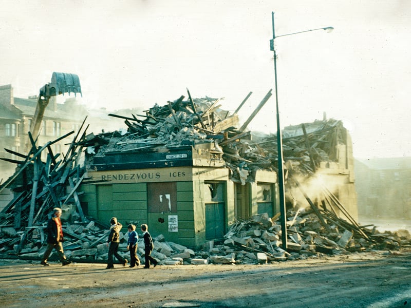 Block of working-class tenements in Hyndland Street, Partick, being demolished. The flats were likely built in the late 1840s to house workers in the Meadowside Shipbuilding Yard of Tod and Macgregor, which had been laid out in 1847. The corner shop was typical of such developments.