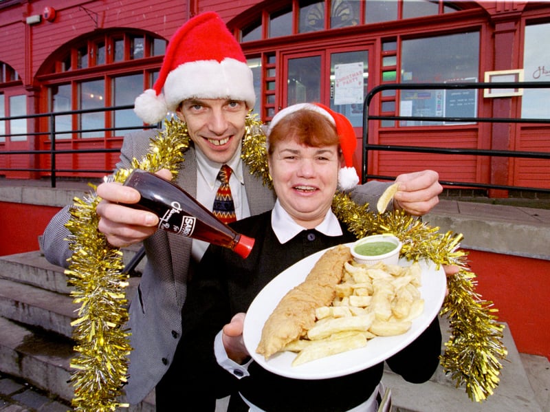 Rupert Edmonds, general manager of  Harry Ramsden's, and waitress  Mary Gillespie, holding a plate of fish and chips,  in December 1997. They were among the members of staff who volunteered to give up their own festive celebrations to help serve the city's homeless that Christmas.