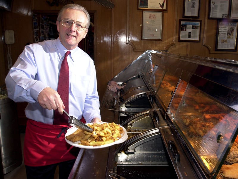 Visit Scotland chief executive Philip Riddle serves fish and chips at the L'Alba D'Oro restaurant, Edinburgh, in January 2002