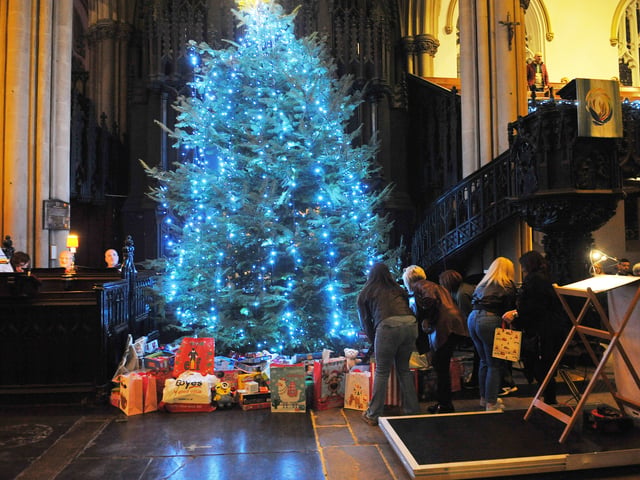 Presents are placed under the tree for Cash For Kids Mission Christmas