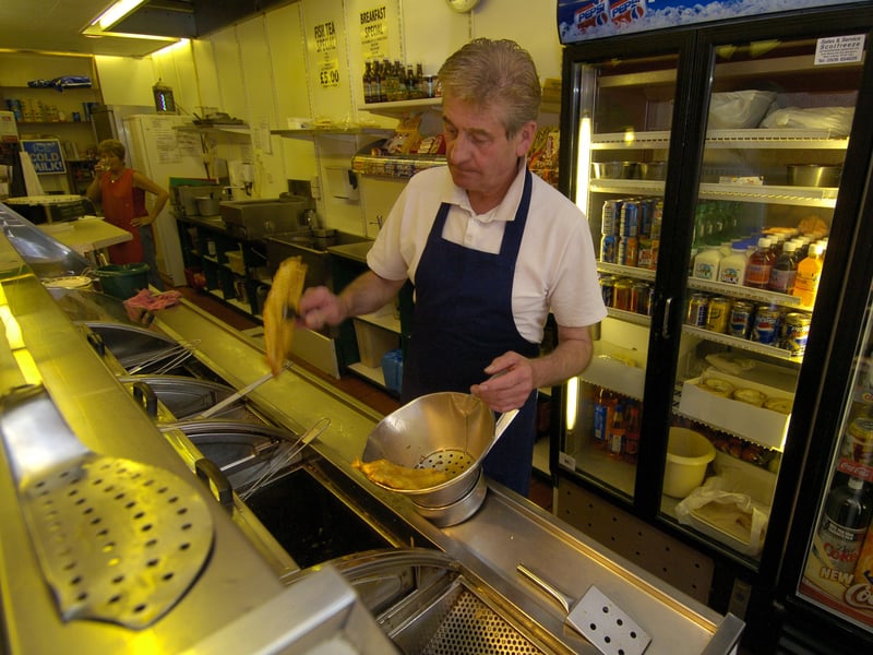 Charles Brattisani frying fish at Brattisani's fish and chip restaurant, on Newington Road, in June 2004