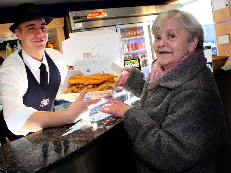 Penicuik resident Kathy Kennedy, who has a gluten-free diet, tucks into her first fish and chip supper in 50 years, served by Domenico Pia, owner of The Tower, in 2010