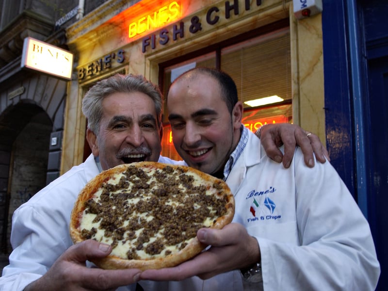 Bene and son Carlo Crolla, from Bene's chip shop, on Canongate, Edinburgh, with one of their haggis pizzas, made specially to celebrate the opening of the Scottish Parliament building at Holyrood, in  2004