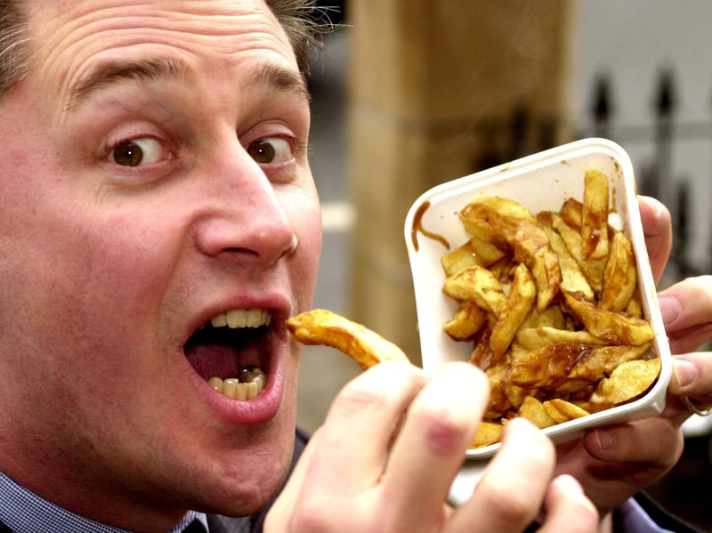 Belgian consul Yves Lemarchand enjoys some chips from Brattisani's in Stockbridge, Edinburgh, in February 2000