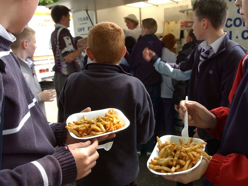 School pupils gather outside a fast food van at Bannerman High School, Baillieston, Glasgow, in June 2005