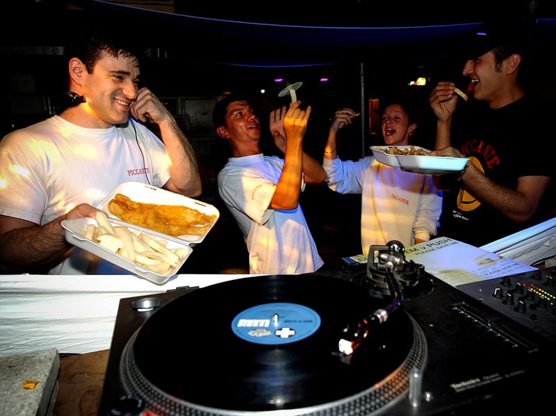 Staff members Fabio Barbie (DJ Fabio B), Selim Sener (DJ Sal), Angela McDevitt (Queen) and Mazhar Altun Kaya (DJ Marco) at the Piccante chip shop, on Broughton Street, Edinburgh, where they run a club, in 2002