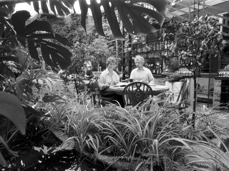 A couple eating in the Green Conservatory of The Ubiquitous Chip restaurant, Glasgow, in May 1988