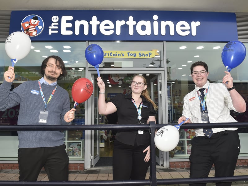 Mike Dawes, store manager, Charley Woodley, assistant manager and Alex Dickenson, store supervisor, celebrate the opening of The Entertainer on Friday, December 5.