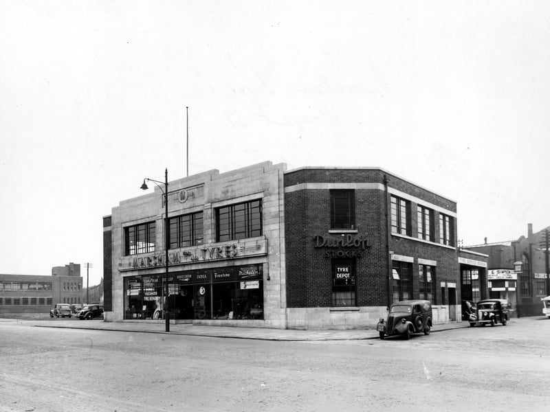 Marsham Tyre Co. Ltd. on Regent Street. Dunlop Tyre Depot on corner with Hope Road. Globe and Simpson automobile repairs visible. Pictured in October 1948.
